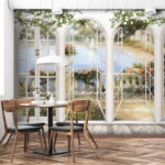 Fotobehang Landschappelijk uitzicht door gewelfde deuren.