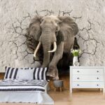 Fotobehang Olifant die door de muur barst.