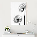 Canvas Schilderijen Silhouetten van paardenbloemen wapperend in de wind.