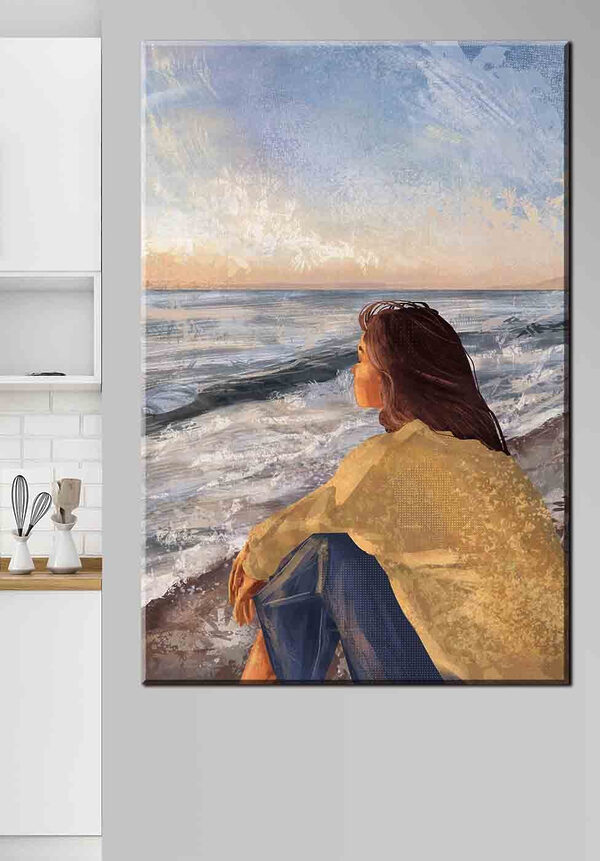 Vrouw zittend op een strand met uitzicht op de oceaan Canvas Schilderijen Vrouw zittend op een strand met uitzicht op de oceaan