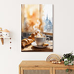 Canvas Schilderijen Kopje koffie en croissants op een tafel