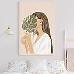 Canvas Schilderijen Vrouw die een blad vasthoudt