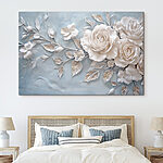 Canvas Schilderijen Witte bloemen en bladeren op een blauw oppervlak