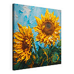 Canvas Schilderijen Zonnebloemen bloeien tegen een blauwe achtergrond