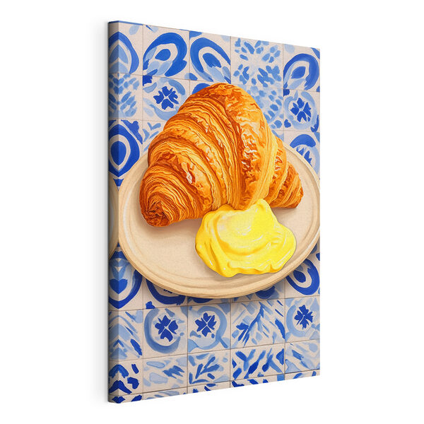 Een croissant en een gele vloeistof op een bord Canvas Schilderijen Een croissant en een gele vloeistof op een bord