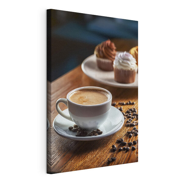 Canvas Schilderijen Kopje koffie en cupcakes op een tafel